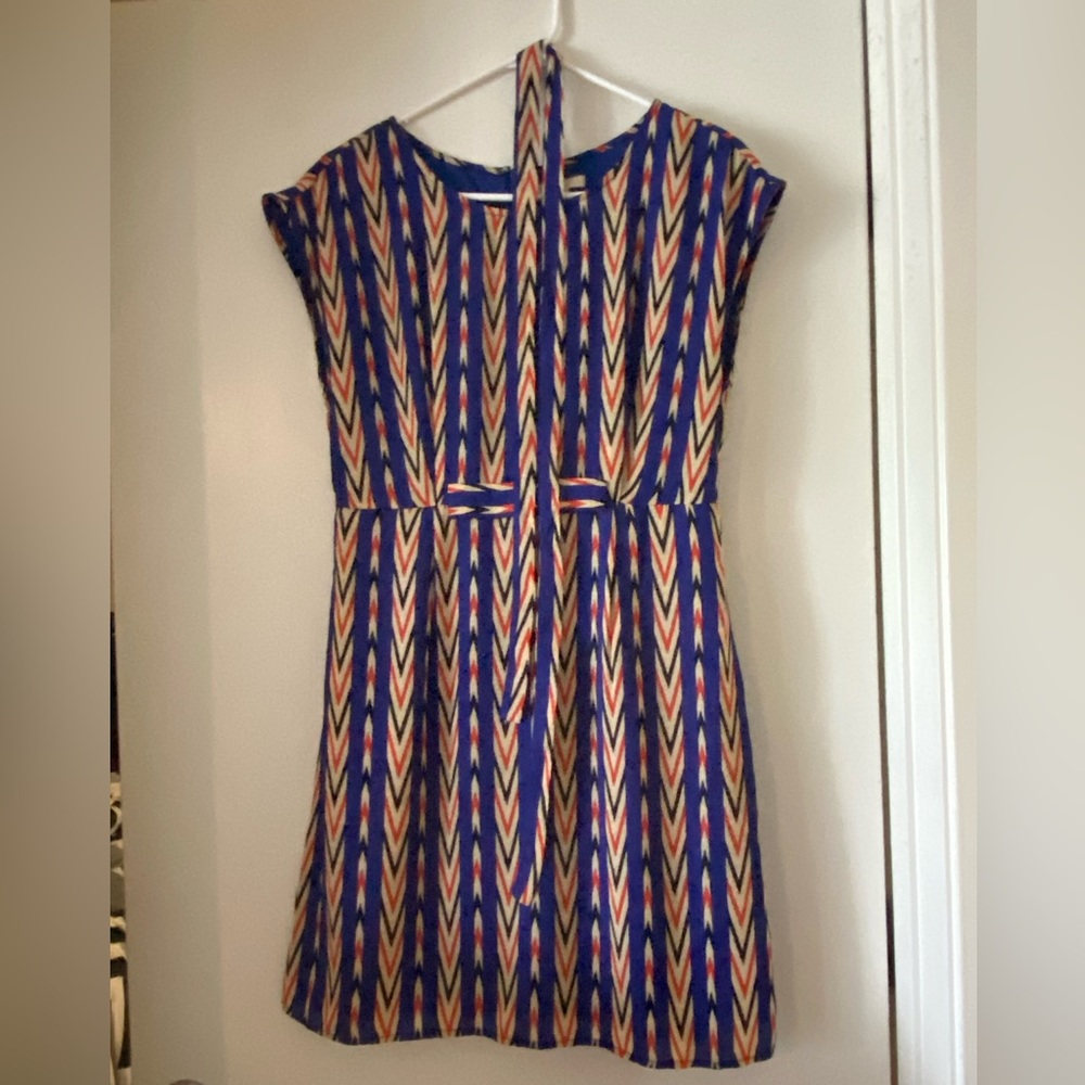 Knee length short sleeved Tulle dress. Never worn. Zips in back.